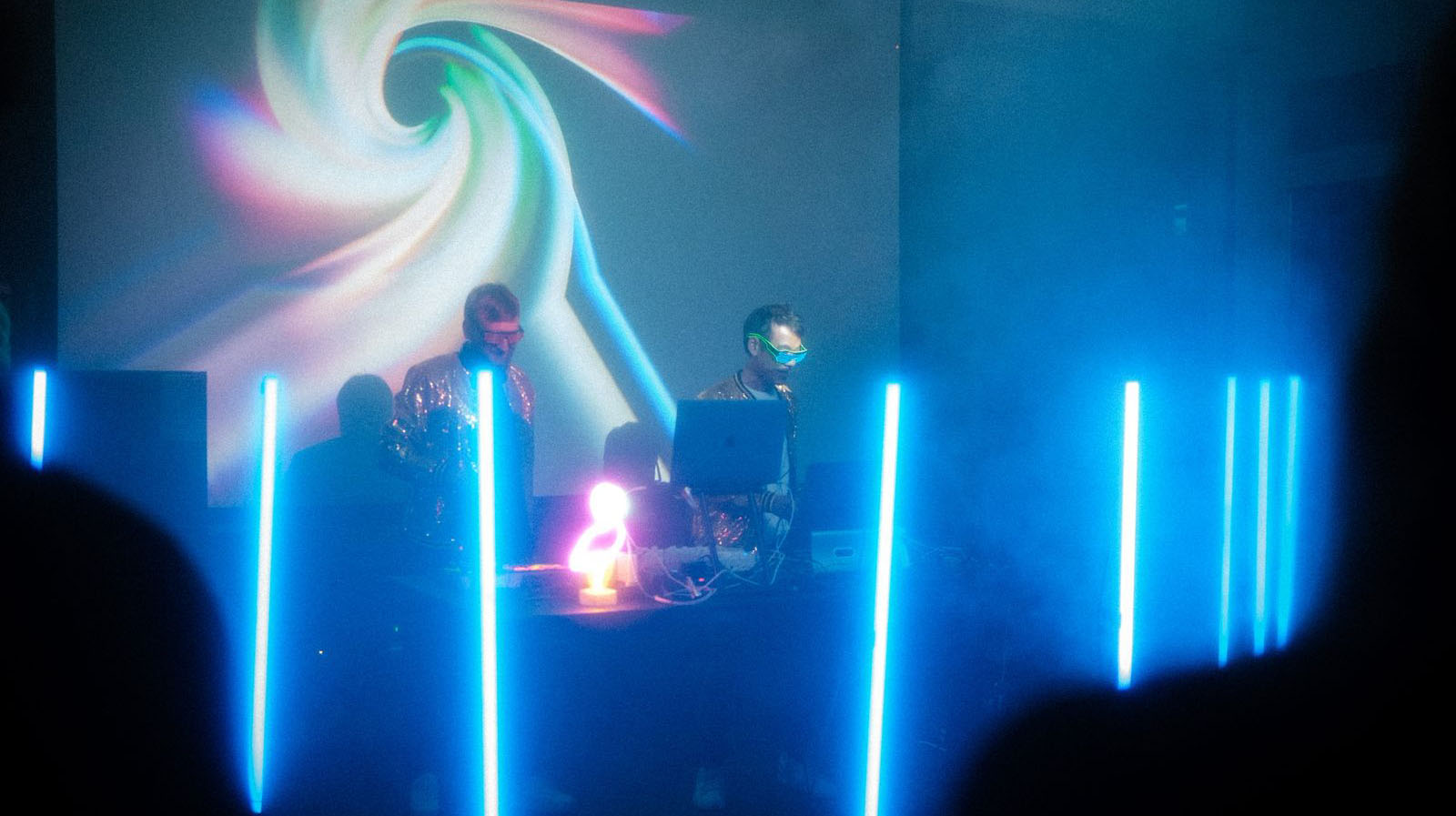 2 musicians playing music in front of a LED wall